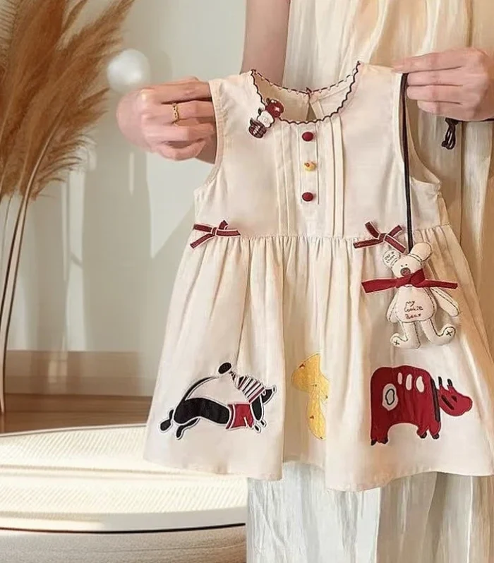 junior Kominz Baby Girl Dress – Sleeveless Cotton with Embroidery and Teddy Charm.